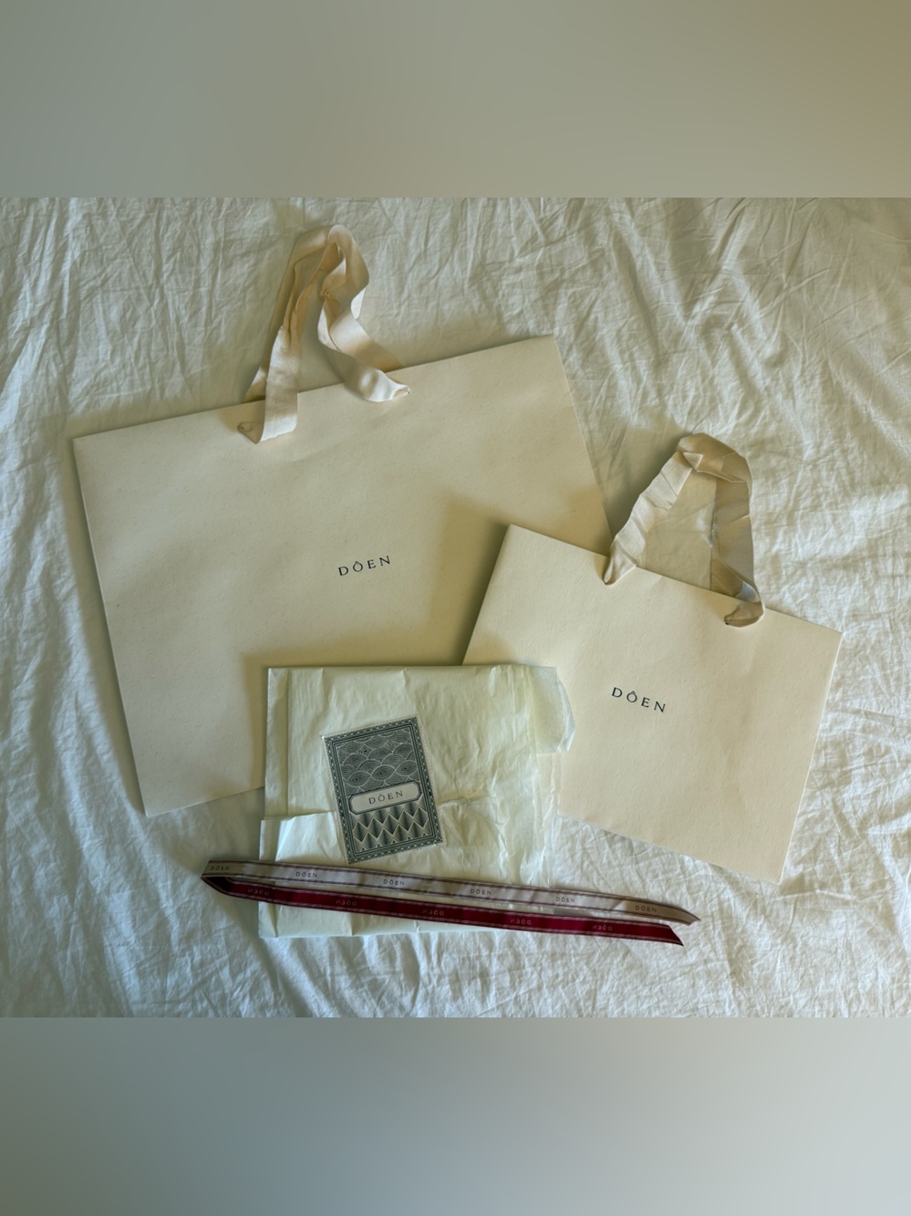 DÔEN paper shopping totes, wrapping paper, and ribbon